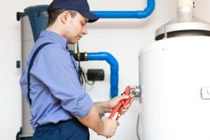technician repairing hot-water heater